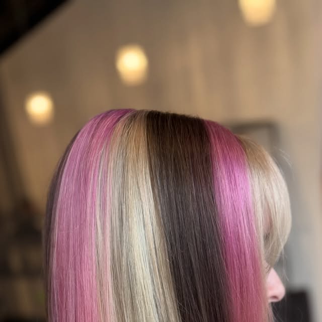 Blonde, brunette and pink colour-blocked hair with a fringe